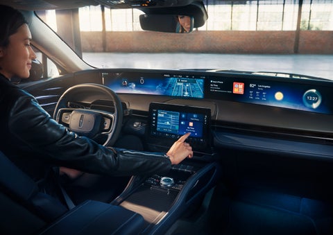 The driver of a 2024 Lincoln Nautilus® SUV interacts with the center touchscreen. | Oliver Lincoln in Plymouth IN
