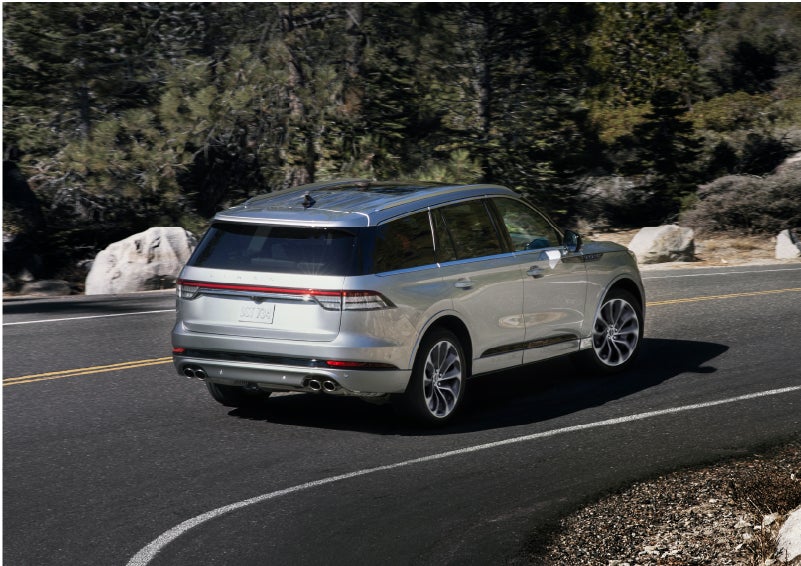 A Lincoln Aviator® is being driven on a winding road | Oliver Lincoln in Plymouth IN