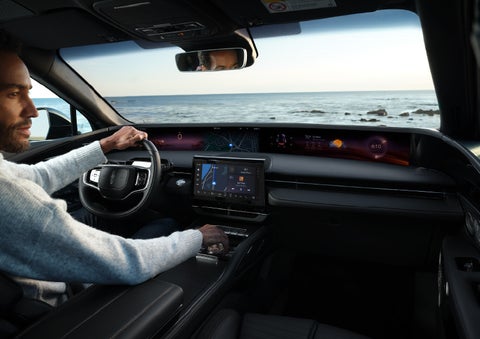 A driver of a parked 2024 Lincoln Nautilus® SUV takes a relaxing moment at a seaside overlook while inside his Nautilus. | Oliver Lincoln in Plymouth IN